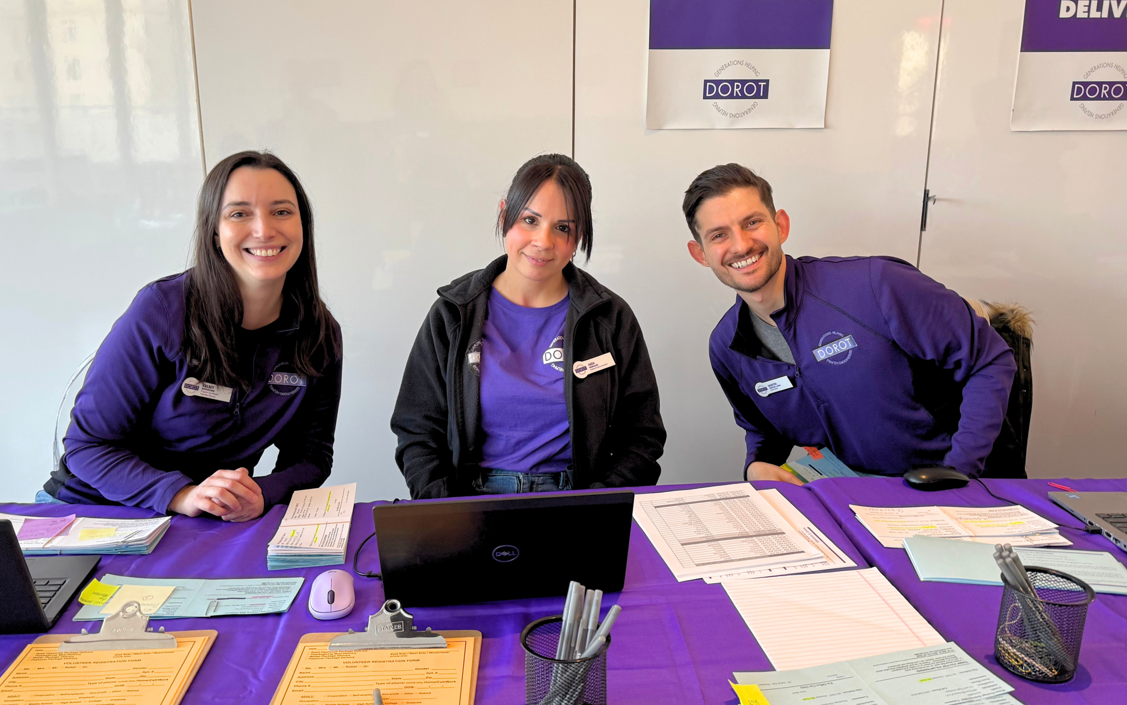 DOROT staff smiling and ready to welcome volunteers at our holiday package delivery.