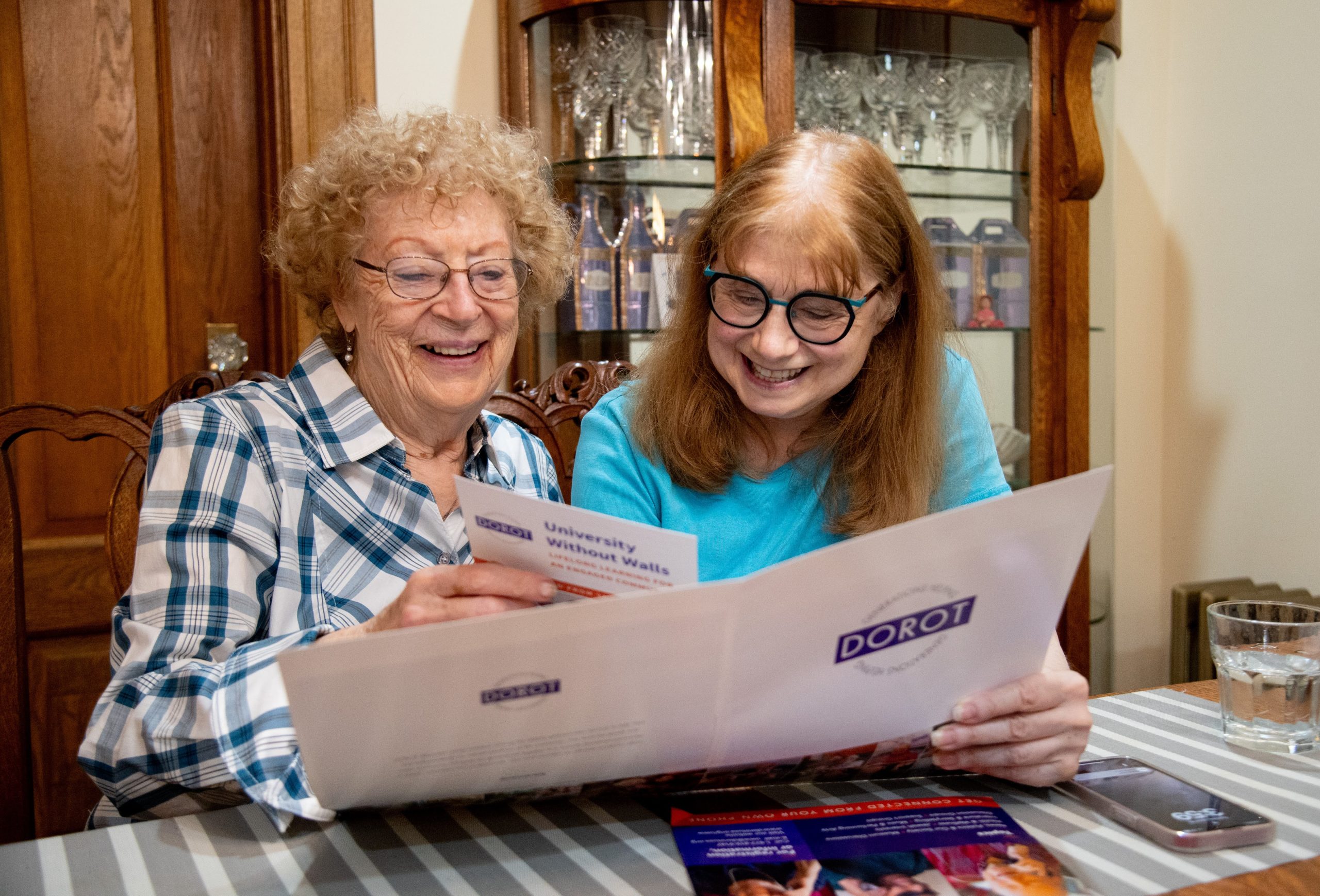 DOROT community members reviewing information and materials about the organization.