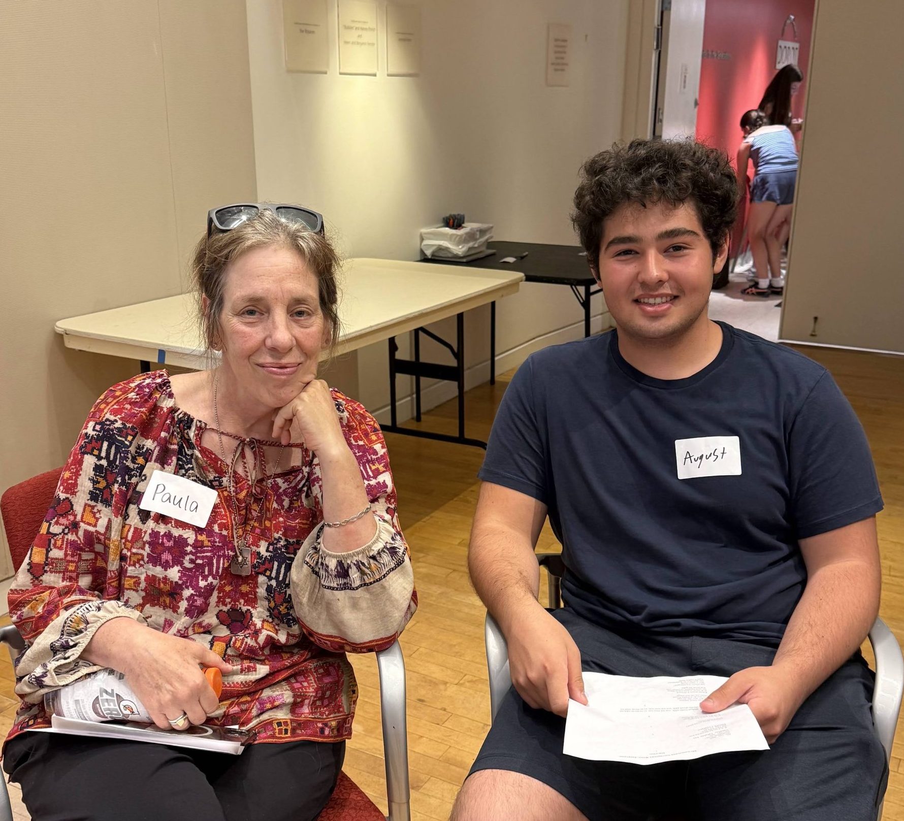 Teen intern and older adult enjoying a program together.