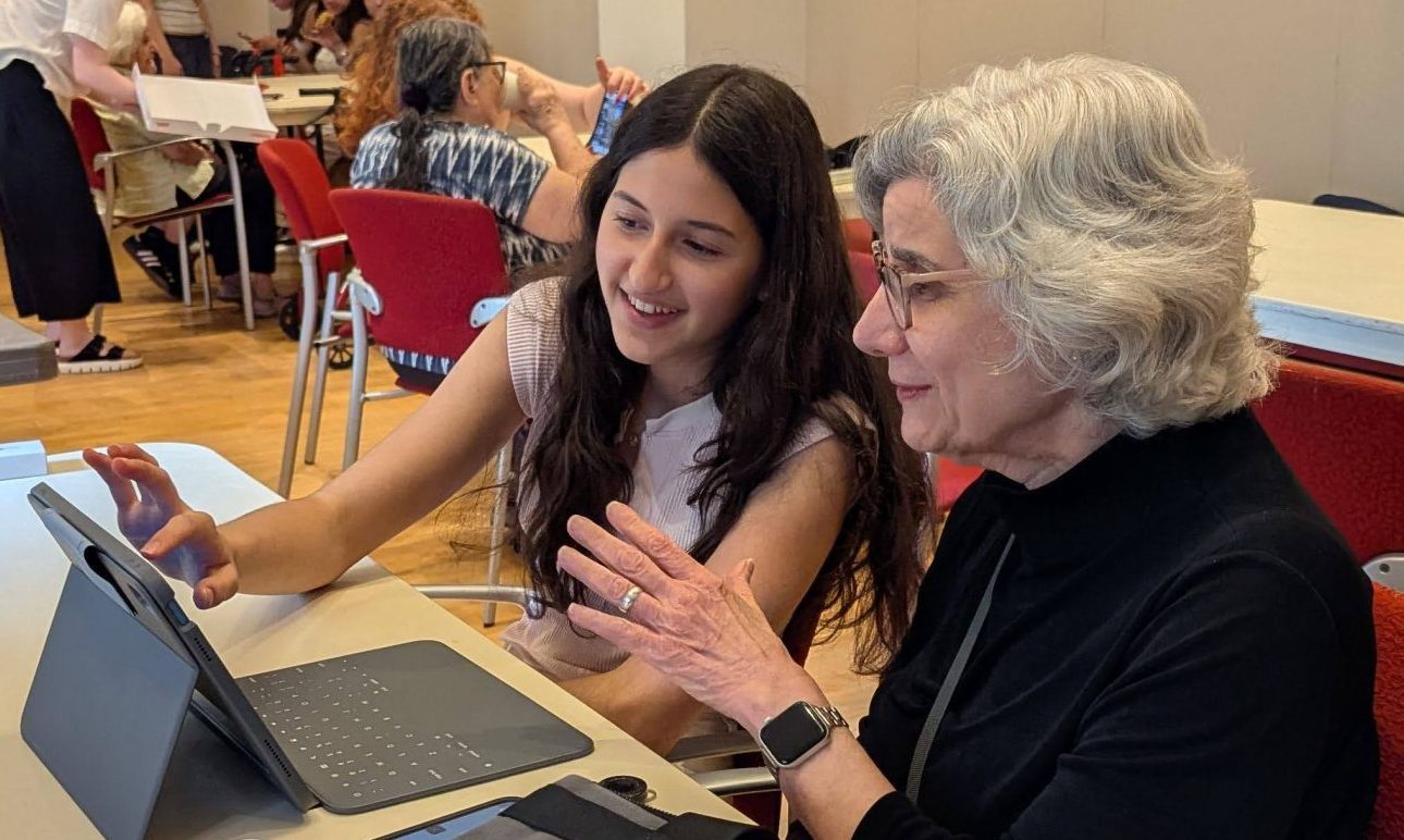 Teen Assists DOROT adult with her tablet