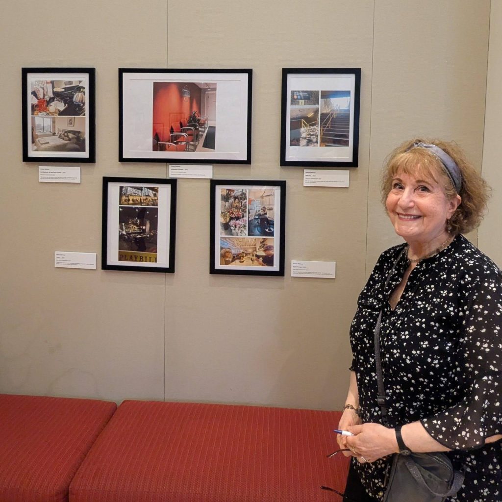 An older adult stands in front of five photographs displayed on a wall, which she took to describe a day in her life.
