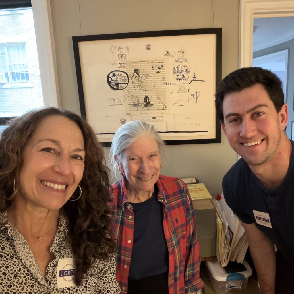 A woman, older woman, and younger man pose together smiling