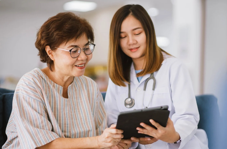A doctor and patient looking at MyChart on a tablet.