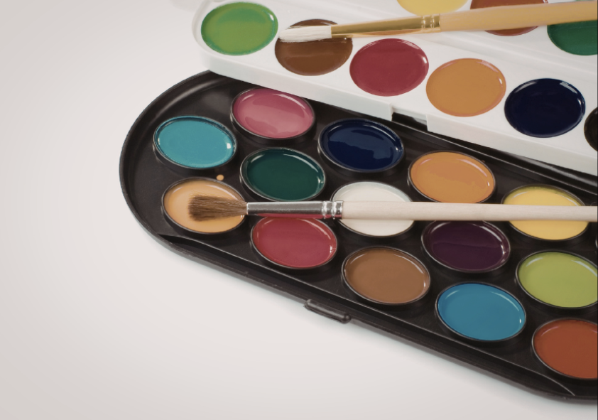 two paint palettes with two paintbrushes on top of them