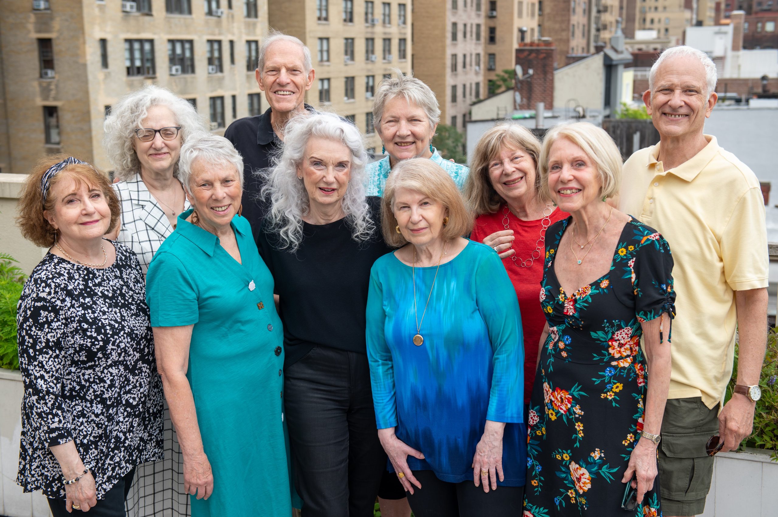 Older adult participants in DOROT's Aging Alone Together program pose together, smiling.