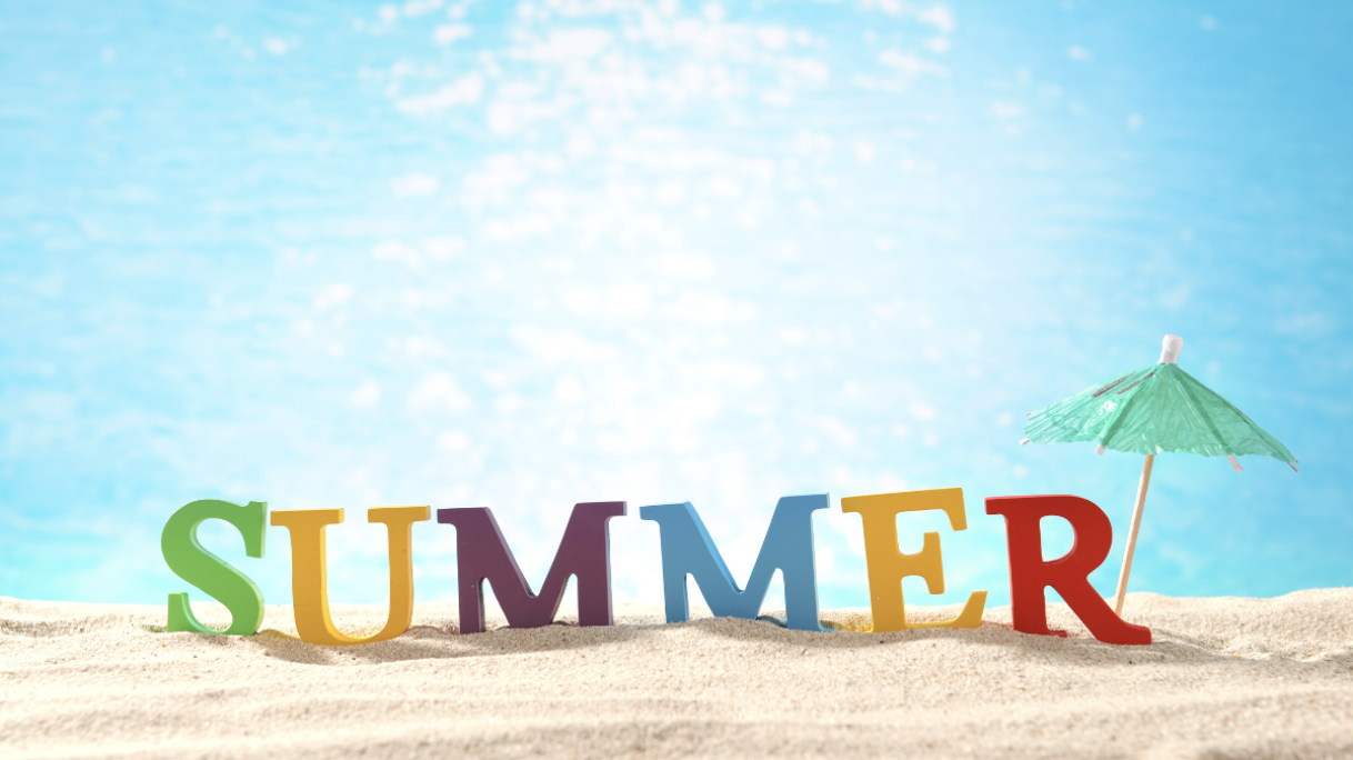 Image of word "summer" with umbrella and beach background.